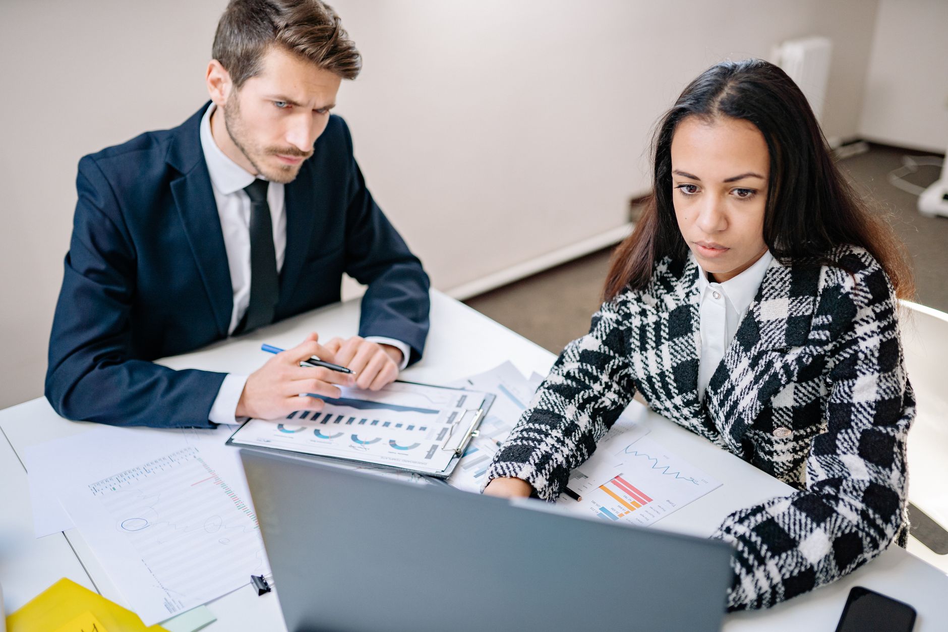 A business owner and an operator reviewing plans together at a desk